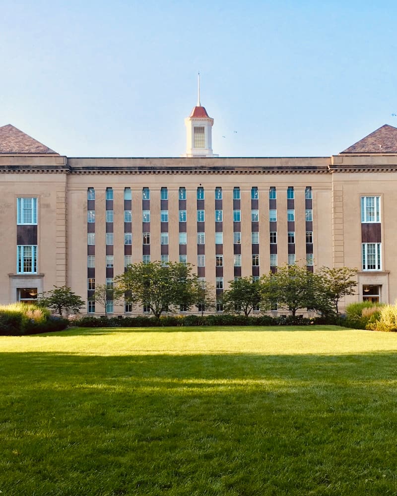 Students walking in front of a prestigious American university building